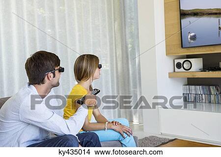 Picture - Man and his daughter watching a 3D movie. Fotosearch