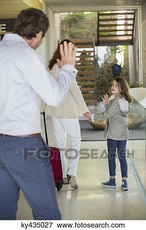 Stock Photo - Man waving to his daughter leaving home. Fotosearch