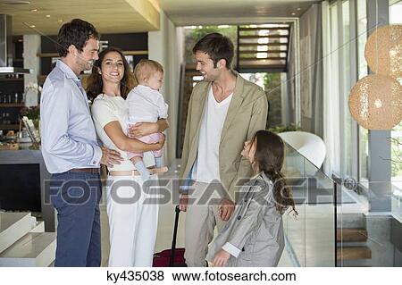 Man with his daughter arriving from holiday at his friends home View Large Photo Image Stock Photo - Man with his daughter arriving from holiday at his friends home. Fotosearch