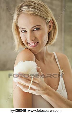 Beautiful smiling woman cleaning with a bath sponge View Large Photo Image Stock Photography - Beautiful smiling woman cleaning with a bath sponge. Fotosearch