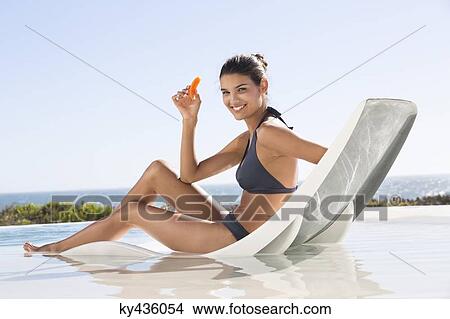 Beautiful woman eating a slice of papaya View Large Photo Image Picture - Beautiful woman eating a slice of papaya. Fotosearch