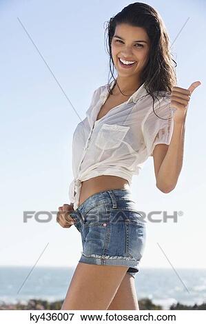 Beautiful woman gesturing on the beach View Large Photo Image Stock Photo - Beautiful woman gesturing on the beach. Fotosearch