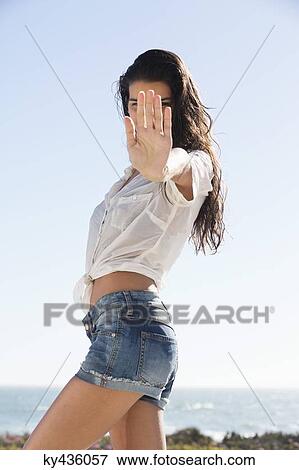 Beautiful woman showing stop gesture on the beach View Large Photo Image Stock Photo - Beautiful woman showing stop gesture on the beach. Fotosearch