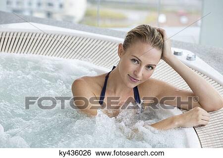 Portrait of a beautiful woman in a hot tub View Large Photo Image Stock Photograph - Portrait of a beautiful woman in a hot tub. Fotosearch
