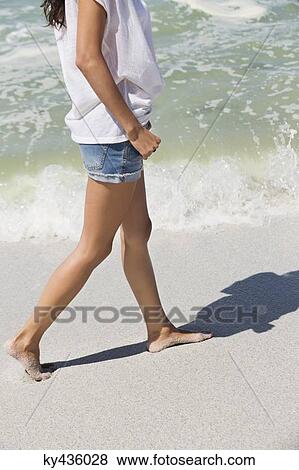 Woman walking on the beach View Large Photo Image Stock Photo - Woman walking on the beach. Fotosearch