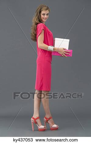 Portrait of a woman carrying boxes and smiling View Large Photo Image Stock Image - Portrait of a woman carrying boxes and smiling. Fotosearch