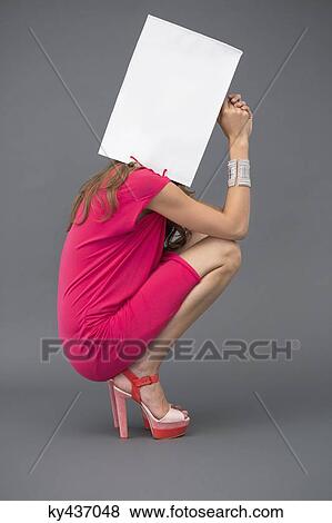 Woman holding a shopping bag over her face View Large Photo Image Stock Photo - Woman holding a shopping bag over her face. Fotosearch