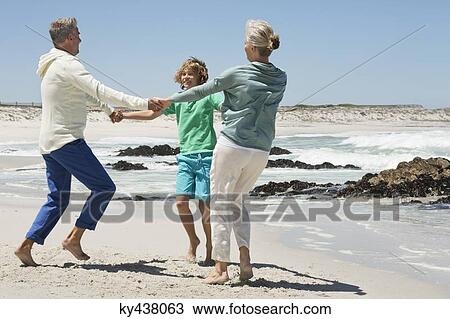 Boy playing with his grandparents on the beach View Large Photo Image Stock Image - Boy playing with his grandparents on the beach. Fotosearch