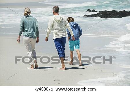 Boy walking with his grandparents on the beach View Large Photo Image Stock Photography - Boy walking with his grandparents on the beach. Fotosearch