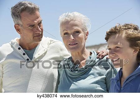 Boy with his grandparents on the beach View Large Photo Image Picture - Boy with his grandparents on the beach. Fotosearch