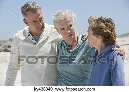 Boy with his grandparents on the beach View Large Photo Image Stock Image - Boy with his grandparents on the beach. Fotosearch