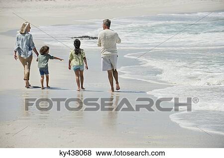 Children walking with their grandparents on the beach View Large Photo Image Stock Photo - Children walking with their grandparents on the beach. Fotosearch