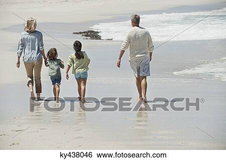 Children walking with their grandparents on the beach View Large Photo Image Stock Photograph - Children walking with their grandparents on the beach. Fotosearch