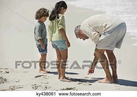 Children with their grandfather on the beach View Large Photo Image Stock Image - Children with their grandfather on the beach. Fotosearch