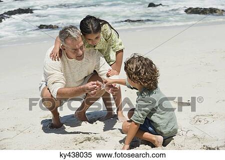 Children with their grandfather on the beach View Large Photo Image Stock Photography - Children with their grandfather on the beach. Fotosearch