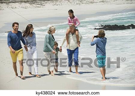Family enjoying on the beach View Large Photo Image Picture - Family enjoying on the beach. Fotosearch