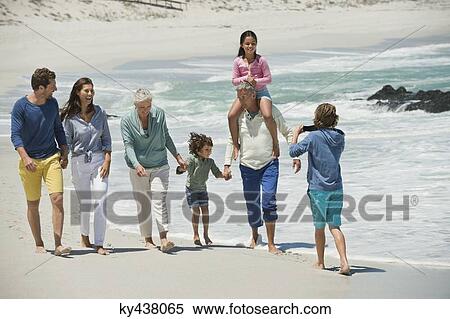 Stock Photography - Family enjoying on the beach. Fotosearch