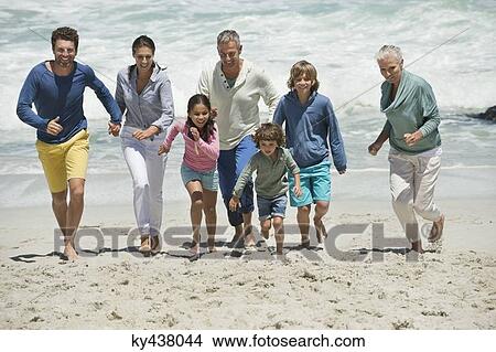 Family running on the beach View Large Photo Image Picture - Family running on the beach. Fotosearch