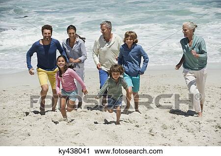 Family running on the beach View Large Photo Image Stock Image - Family running on the beach. Fotosearch