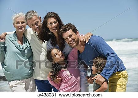 Family smiling on the beach View Large Photo Image Stock Image - Family smiling on the beach. Fotosearch