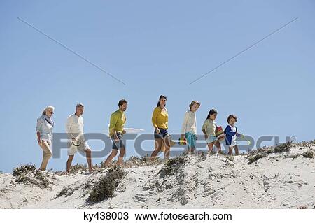 Family walking on the beach View Large Photo Image Stock Image - Family walking on the beach. Fotosearch