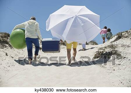 Family walking on the beach View Large Photo Image Stock Image - Family walking on the beach. Fotosearch