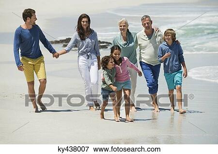 Stock Photo - Family walking on the beach. Fotosearch