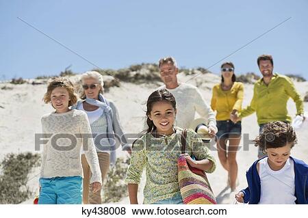 Family walking on the beach View Large Photo Image Stock Photo - Family walking on the beach. Fotosearch