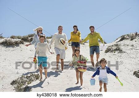 Family walking on the beach View Large Photo Image Stock Photo - Family walking on the beach. Fotosearch