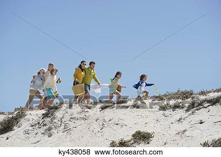 Family walking on the beach View Large Photo Image Stock Photo - Family walking on the beach. Fotosearch