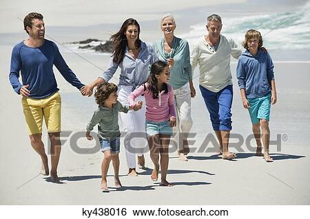 Family walking on the beach View Large Photo Image Stock Photograph - Family walking on the beach. Fotosearch