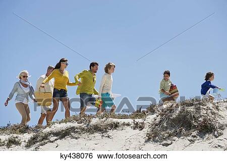 Family walking on the beach View Large Photo Image Stock Photograph - Family walking on the beach. Fotosearch