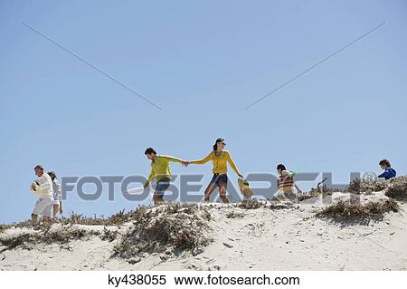 Family walking on the beach View Large Photo Image Stock Photography - Family walking on the beach. Fotosearch