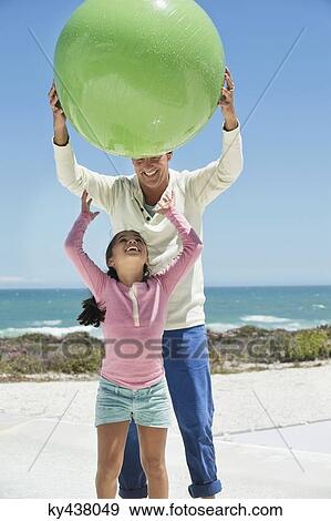Man playing with his granddaughter on the beach View Large Photo Image Stock Photo - Man playing with his granddaughter on the beach. Fotosearch