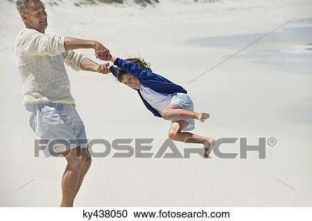 Man playing with his grandson on the beach View Large Photo Image Stock Image - Man playing with his grandson on the beach. Fotosearch