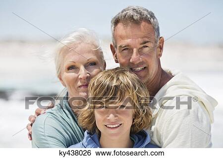 Portrait of a boy with his grandparents on the beach View Large Photo Image Stock Photograph - Portrait of a boy with his grandparents on the beach. Fotosearch
