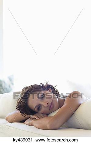 Portrait of a woman lying on the bed View Large Photo Image Stock Image - Portrait of a woman lying on the bed. Fotosearch