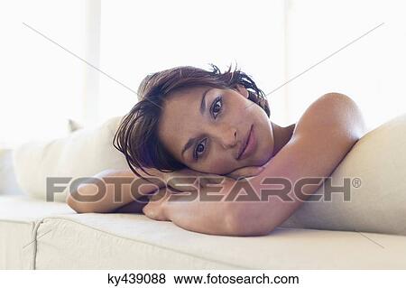 Portrait of a woman lying on the bed View Large Photo Image Stock Photo - Portrait of a woman lying on the bed. Fotosearch