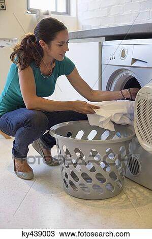 Woman doing laundry at home View Large Photo Image Stock Image - Woman doing laundry at home. Fotosearch