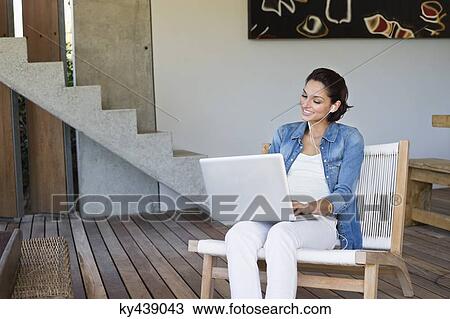 Woman doing online chatting on a laptop View Large Photo Image Stock Image - Woman doing online chatting on a laptop. Fotosearch