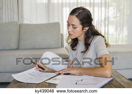 Woman doing paperwork at home View Large Photo Image Stock Photo - Woman doing paperwork at home. Fotosearch
