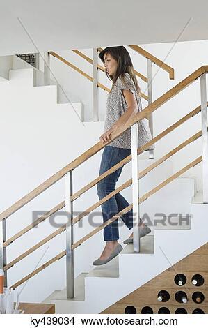 Woman moving down stairs View Large Photo Image Picture - Woman moving down stairs. Fotosearch