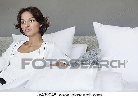 Woman reclining on the bed View Large Photo Image Stock Photography - Woman reclining on the bed. Fotosearch