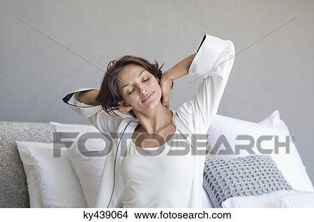 Woman stretching on the bed View Large Photo Image Picture - Woman stretching on the bed. Fotosearch