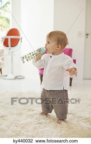 Baby boy drinking water from a bottle View Large Photo Image Stock Image - Baby boy drinking water from a bottle. Fotosearch