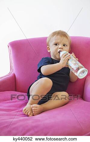Baby boy drinking water from a bottle View Large Photo Image Stock Image - Baby boy drinking water from a bottle. Fotosearch