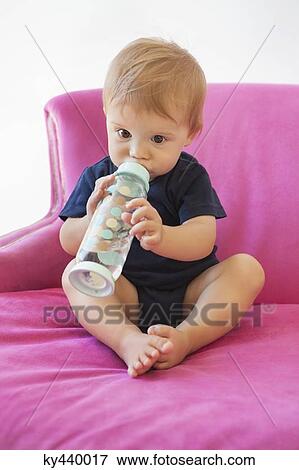 Stock Photo - Baby boy drinking water from a bottle. Fotosearch