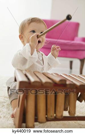 Stock Photo - Baby boy playing a xylophone. Fotosearch