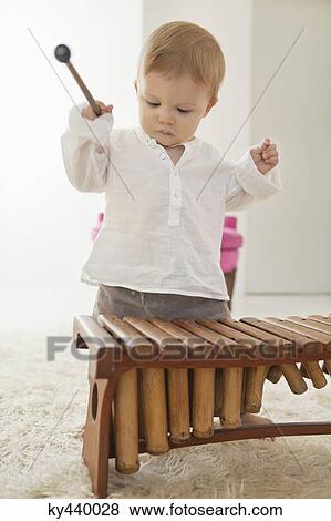 Baby boy playing a xylophone View Large Photo Image Stock Photo - Baby boy playing a xylophone. Fotosearch