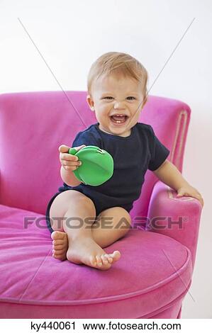 Baby boy playing with a pouch bag View Large Photo Image Stock Image - Baby boy playing with a pouch bag. Fotosearch